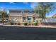 Charming townhome featuring a well-kept lawn, decorative accents, and a welcoming facade at 1101 Elation Ln # 2, Henderson, NV 89002