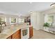 Bright kitchen featuring a dishwasher, sink, and dining area with a view of the backyard at 1101 Elation Ln # 2, Henderson, NV 89002