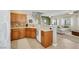 Open-concept kitchen with wooden cabinets, stainless steel sink, and seamless flow into the living space at 1101 Elation Ln # 2, Henderson, NV 89002