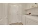 Functional laundry room with washer, dryer, and storage shelves at 1101 Elation Ln # 2, Henderson, NV 89002