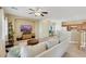 Spacious living room with an open floor plan, neutral color scheme, and seamless flow to the kitchen at 1101 Elation Ln # 2, Henderson, NV 89002