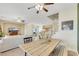 Bright living room with neutral walls, a large sectional sofa, and a rustic wooden dining table at 1101 Elation Ln # 2, Henderson, NV 89002