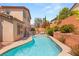 Backyard swimming pool with patio, plants and the house in the background at 11226 Kenyan Sunshine Ct, Las Vegas, NV 89138