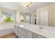 Bright and modern bathroom features a double sink vanity, soaking tub, walk-in shower and window with natural light at 11226 Kenyan Sunshine Ct, Las Vegas, NV 89138