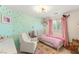 Cozy bedroom with mint accent wall, gold polka dots, and eclectic décor, offering a charming and personalized space at 11226 Kenyan Sunshine Ct, Las Vegas, NV 89138