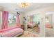 Bright bedroom with large mirrored closet, pink accents and ample natural light creating a cheerful and inviting atmosphere at 11226 Kenyan Sunshine Ct, Las Vegas, NV 89138