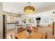 Open kitchen and dining area with bar seating, stainless steel appliances, and backyard views at 11226 Kenyan Sunshine Ct, Las Vegas, NV 89138