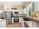 Modern kitchen with granite countertops, stainless steel appliances, and bright natural lighting at 11226 Kenyan Sunshine Ct, Las Vegas, NV 89138