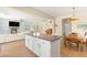 Stylish open kitchen with a large island, stainless appliances, and a seamless transition to the cozy living room at 11226 Kenyan Sunshine Ct, Las Vegas, NV 89138