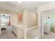 Upstairs landing area with storage cabinets, carpet flooring, and decorative art creating a cozy and functional space at 11226 Kenyan Sunshine Ct, Las Vegas, NV 89138