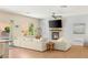 Bright living room with a fireplace, large TV, comfortable seating, and views of the backyard pool at 11226 Kenyan Sunshine Ct, Las Vegas, NV 89138