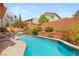 Refreshing backyard pool surrounded by lush landscaping, perfect for relaxation and entertainment at 11226 Kenyan Sunshine Ct, Las Vegas, NV 89138