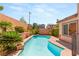 Backyard swimming pool surrounded by lush landscaping and a brick wall, creating a private oasis at 11226 Kenyan Sunshine Ct, Las Vegas, NV 89138