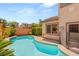 Backyard swimming pool with a tile edge and the house in the background at 11226 Kenyan Sunshine Ct, Las Vegas, NV 89138