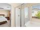 Modern glass enclosed shower and soaking tub with tile surround, and bright window overlooking an exterior view at 11226 Kenyan Sunshine Ct, Las Vegas, NV 89138