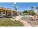 A lush backyard oasis with a sparkling pool, covered patio, and beautiful landscaping at 1128 Galangate Ave, Henderson, NV 89015