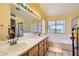 Bright bathroom with dual sinks, vanity, separate tub, and shower at 1128 Galangate Ave, Henderson, NV 89015