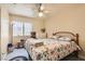 Comfortable bedroom with wood floors, a ceiling fan, and natural light at 1128 Galangate Ave, Henderson, NV 89015
