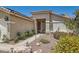 Close-up of a home's entrance with landscaped yard, stone pathway, and desert plants at 1128 Galangate Ave, Henderson, NV 89015