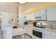Functional kitchen featuring white cabinets, stainless steel appliances, and an island with seating at 1128 Galangate Ave, Henderson, NV 89015