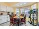 Bright breakfast nook featuring white cabinets, backyard views, and a charming wooden table set at 1128 Galangate Ave, Henderson, NV 89015