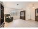 Bright living room featuring wood-look floors, dark wood cabinets, and a comfortable recliner at 1128 Galangate Ave, Henderson, NV 89015