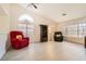 Open living room featuring wood-look floors, two recliners, and bright natural light at 1128 Galangate Ave, Henderson, NV 89015