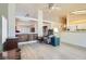 Cozy living room featuring vaulted ceilings, wood floors, and an open floor plan to the kitchen at 1128 Galangate Ave, Henderson, NV 89015