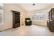 Bright living room featuring wood-look floors, dark wood cabinets, and a comfortable recliner at 1128 Galangate Ave, Henderson, NV 89015