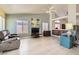 Inviting living room with vaulted ceilings, a ceiling fan, and wood floors and cabinetry at 1128 Galangate Ave, Henderson, NV 89015