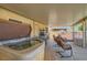 Relax in the covered patio with a hot tub and comfortable seating with garden views at 1128 Galangate Ave, Henderson, NV 89015