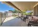 Relax in the covered patio with comfortable seating and views of the landscaped backyard at 1128 Galangate Ave, Henderson, NV 89015