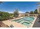 This backyard features a sparkling pool with a built-in spa and desert landscaping at 1128 Galangate Ave, Henderson, NV 89015