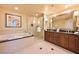 Modern bathroom with large tub, walk-in shower, and double sink vanity at 145 E Harmon Ave # 919, Las Vegas, NV 89109
