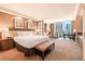 Bright bedroom with a comfortable king bed, seating area, and floor to ceiling windows at 145 E Harmon Ave # 919, Las Vegas, NV 89109