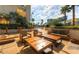 Outdoor courtyard setting with lounge chairs, tables, and chairs; string lights hang above the space with greenery at 145 E Harmon Ave # 919, Las Vegas, NV 89109
