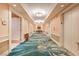 Hallway with patterned carpet, neutral wall decor, and access to elevators for guest convenience at 145 E Harmon Ave # 919, Las Vegas, NV 89109