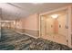 Wide hallway showcasing a patterned carpet, pink walls, and doors leading to guest rooms at 145 E Harmon Ave # 919, Las Vegas, NV 89109