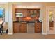 This kitchenette features dark cabinets, stainless steel appliances, a microwave and television at 145 E Harmon Ave # 919, Las Vegas, NV 89109