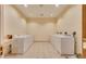 Clean laundry room featuring several white washing machines, and neutral paint at 145 E Harmon Ave # 919, Las Vegas, NV 89109
