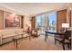 Comfortable living room features a plush sofa, sitting chair, and a beautiful city view at 145 E Harmon Ave # 919, Las Vegas, NV 89109