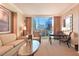 Comfortable living room with city views, a cozy sofa, armchair, and a modern glass coffee table at 145 E Harmon Ave # 919, Las Vegas, NV 89109