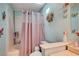 This bathroom features a tub with shower, decorative curtains, and butterfly decor at 1847 Stevens St, Las Vegas, NV 89115