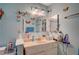 A bathroom featuring a large mirror and vanity sink, adorned with colorful decorations at 1847 Stevens St, Las Vegas, NV 89115