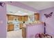 Bright kitchen with wooden cabinets, tile floors, and decorative butterfly accents at 1847 Stevens St, Las Vegas, NV 89115