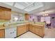 Kitchen with wood cabinets, breakfast bar, tile flooring and open flow to dining area at 1847 Stevens St, Las Vegas, NV 89115