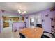 Open kitchen with wooden cabinets, connected to a dining area with butterfly decor at 1847 Stevens St, Las Vegas, NV 89115