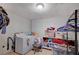 Laundry room with washer, dryer, tile flooring, and open storage for organizing items at 1847 Stevens St, Las Vegas, NV 89115