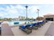 Outdoor pool area with lounge chairs and a distant view of a tall structure at 200 W Sahara Ave # 3303, Las Vegas, NV 89102
