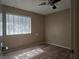 Bedroom featuring wood flooring, window with blinds, and ceiling fan at 2116 Bavington Dr # C, Las Vegas, NV 89108